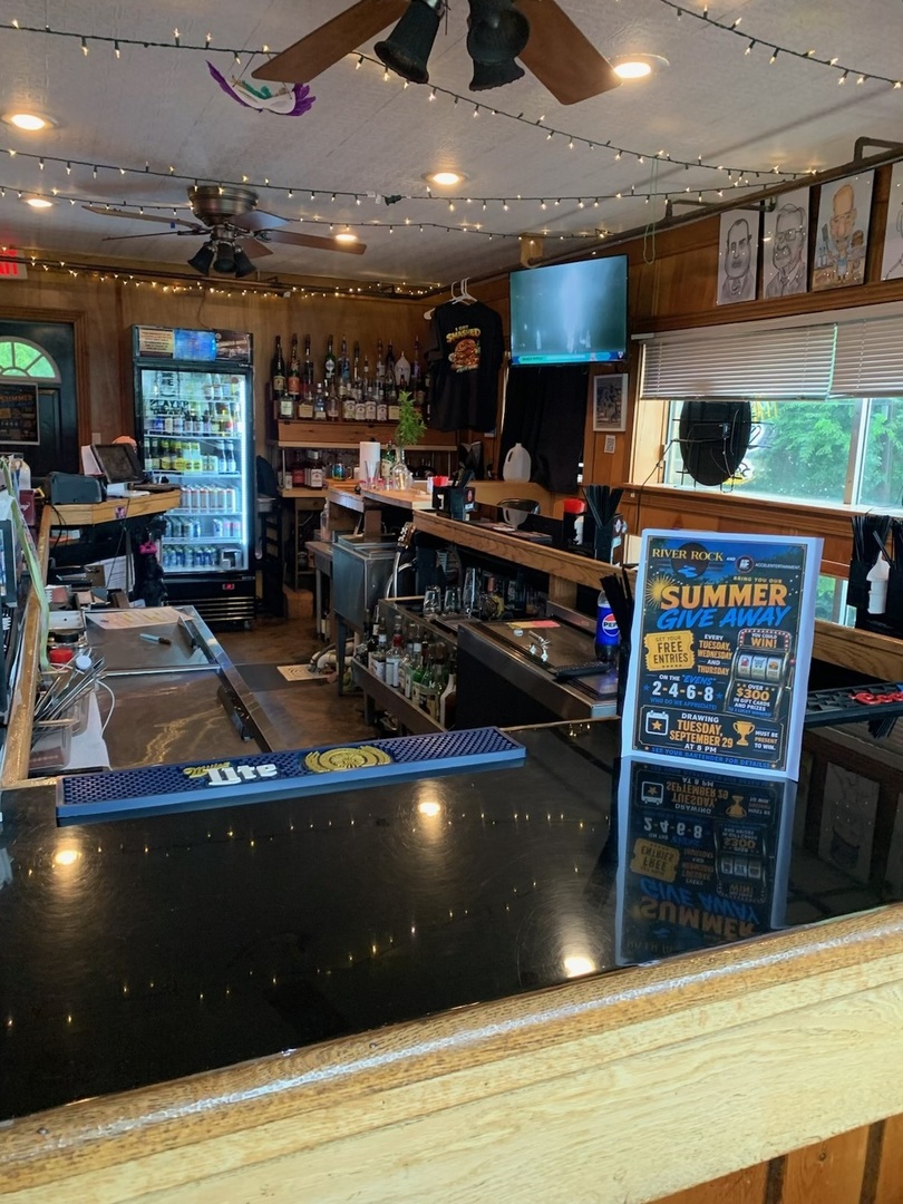 Full-service bar with coolers, taps, and string lighting